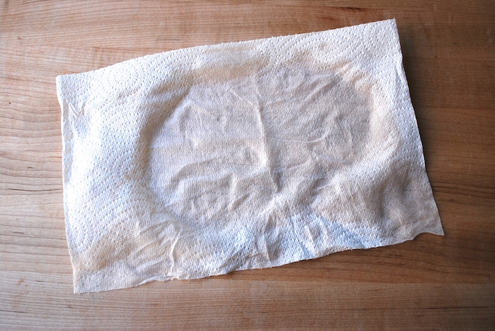 Place a damp paper towel underneath parchment to prevent sliding when rolling out dough.