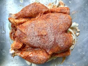 Chicken on baking sheet seasoned.
