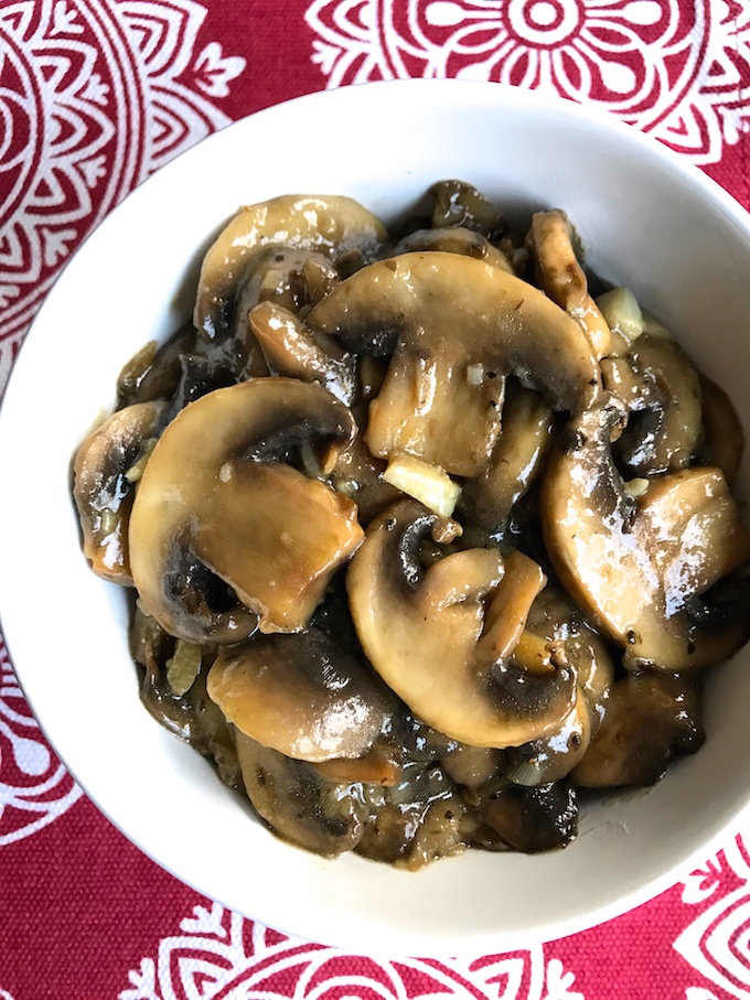 Sliced mushrooms sautéed in olive oil, flavored with garlic, then finished with a splash of wine. Makes a wonderful side or topping to just about anything.