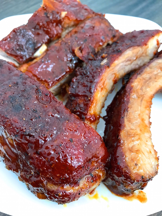 Tender, flavorful, Ultimate Oven Baked BBQ Ribs cooked low and slow. Rubbed with my Sweet and Spicy BBQ Rub and coated with my ten minute Sweet and Spicy BBQ Sauce. Perfection.