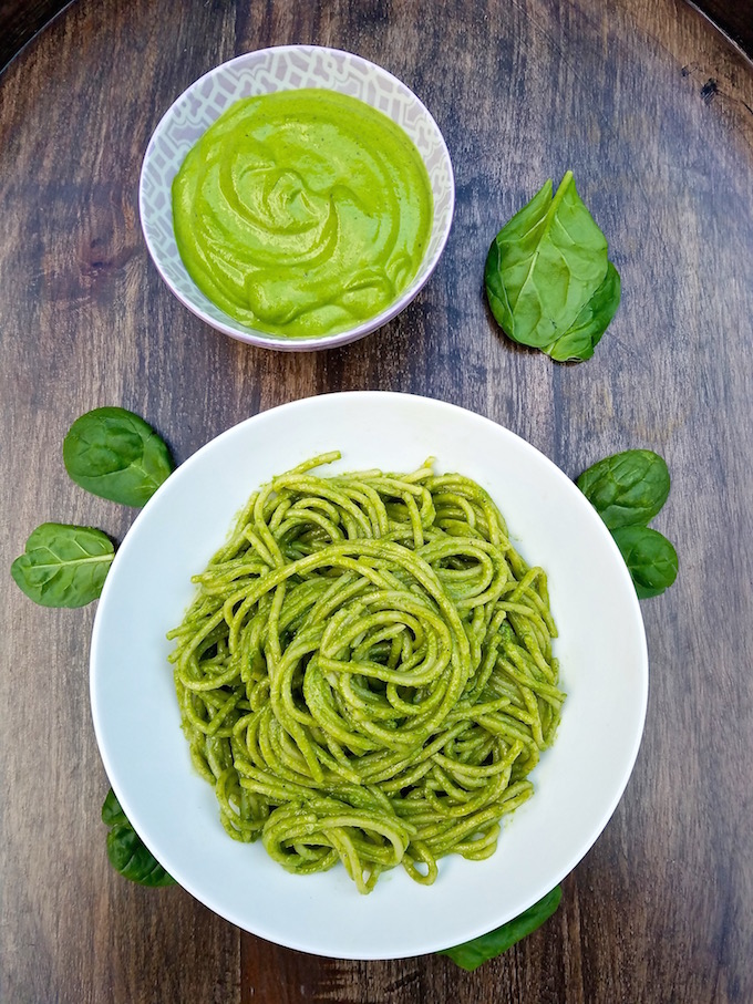 Plate of spinach pesto and bowl of pesto sauce.
