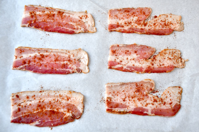 Slices of bacon sprinkled with spice.