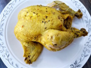 A whole cooked chicken ready for picking.