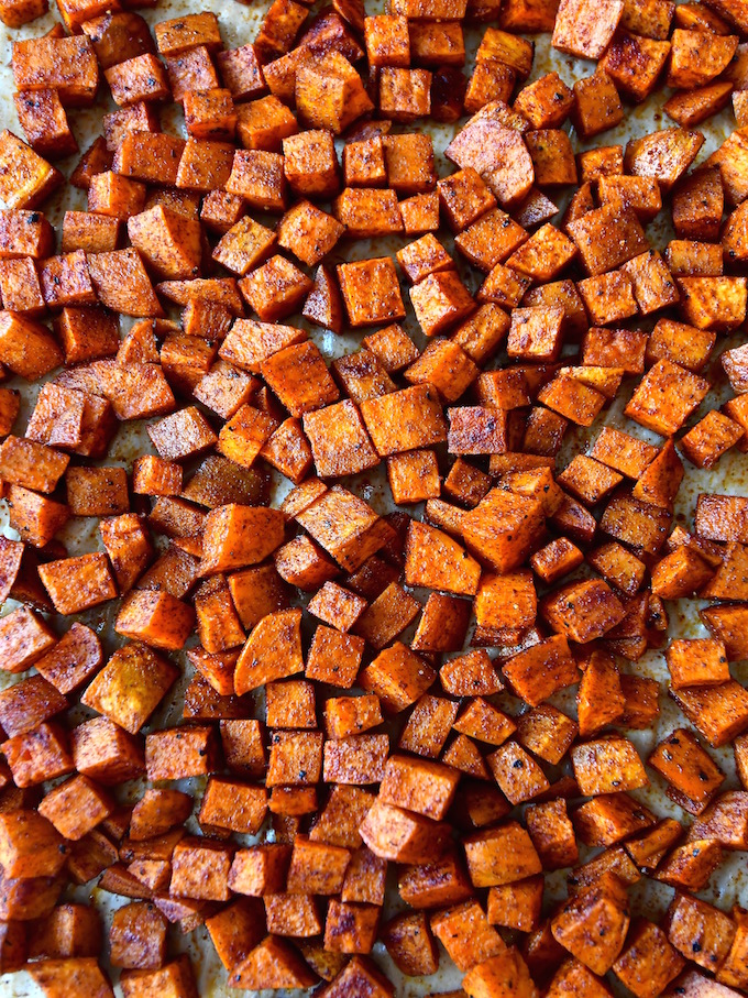 Sheet pan of roasted spiced sweet potatoes.