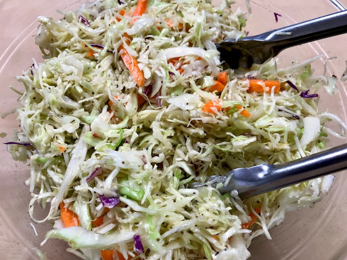 Tossing the coleslaw.