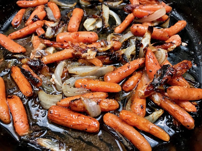 Caramelized onions and carrots in skillet.