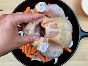 Salting the inside cavity of chicken.