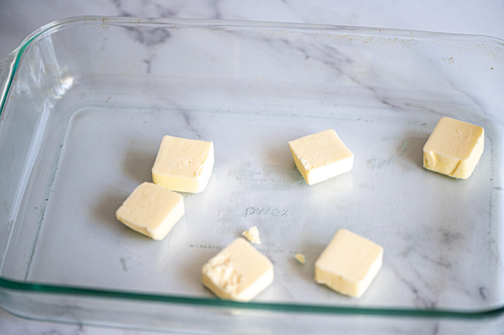 Chunks of butter in a baking dish.