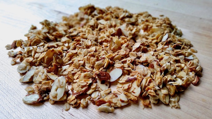 Easy homemade granola spread out on a board.