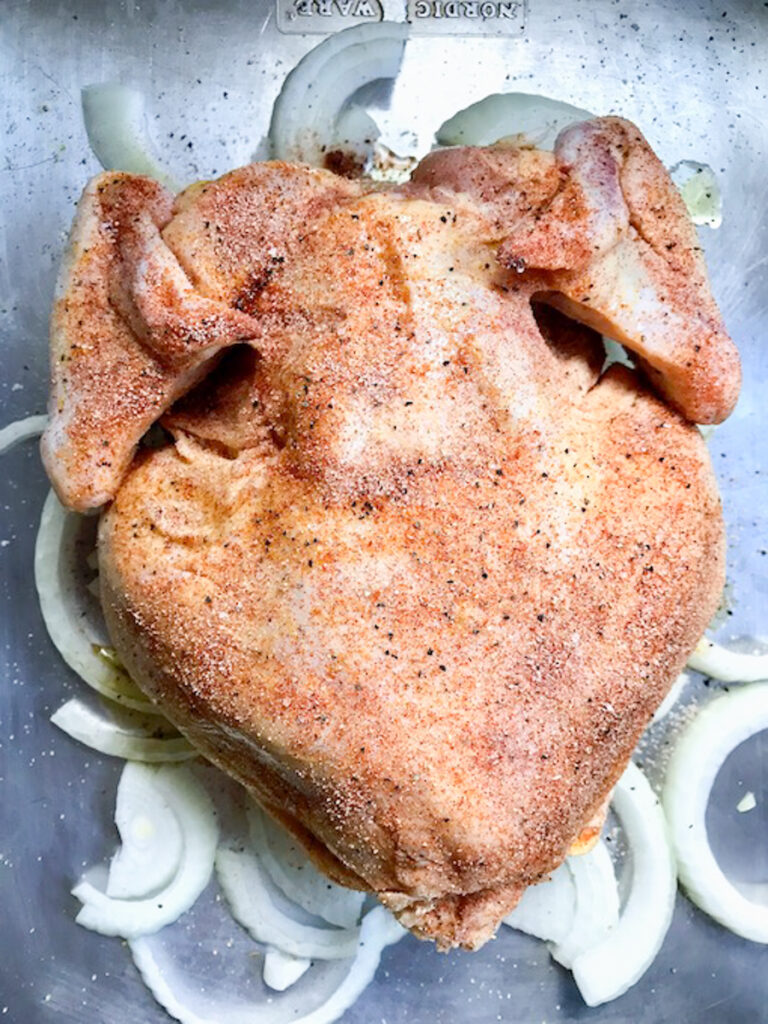 Seasoning the underside of chicken.