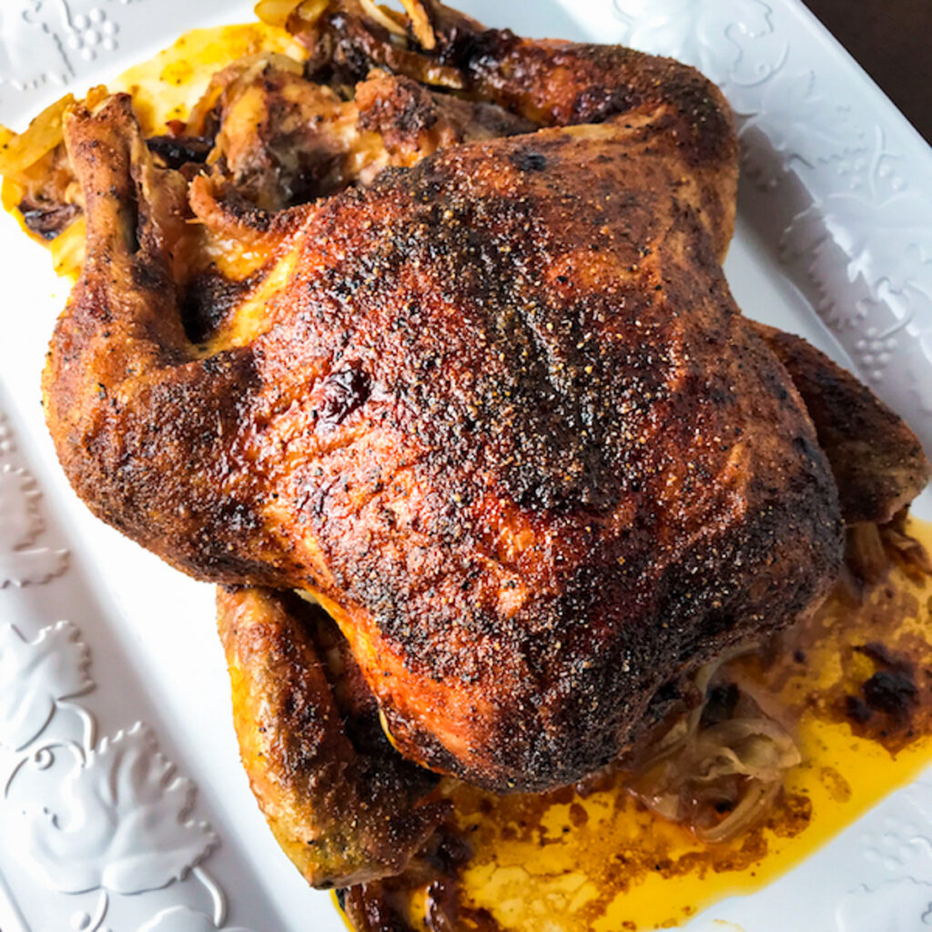 Slow roasted chicken on platter.