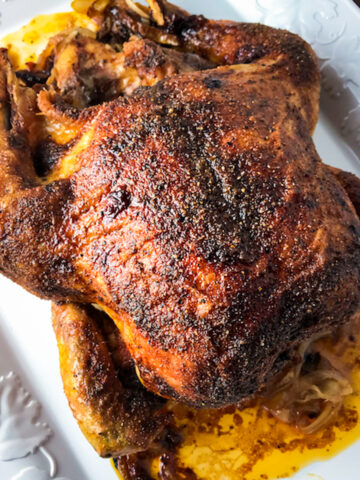 Slow roasted chicken on platter.