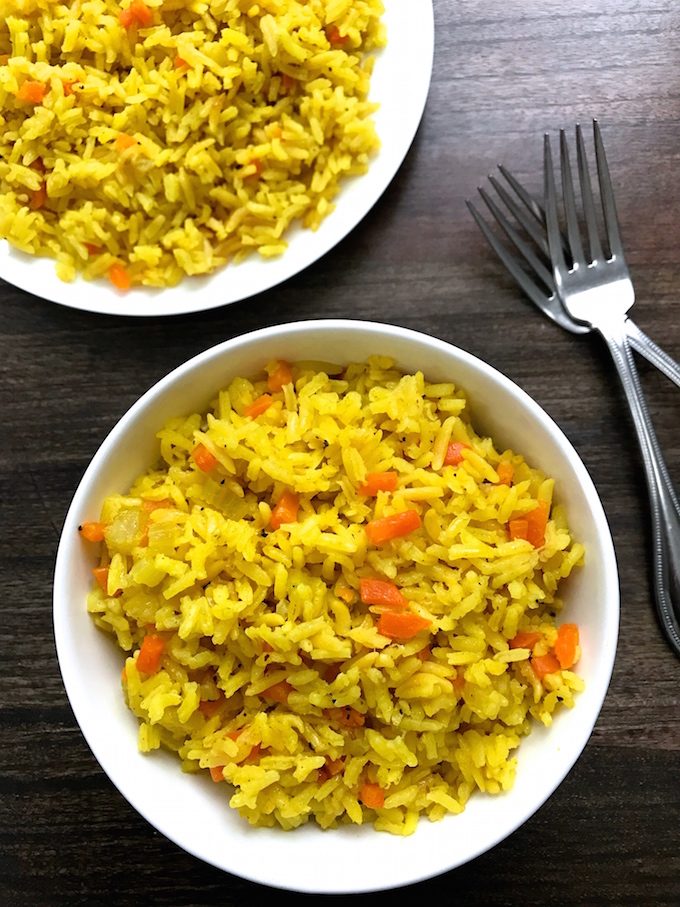 Perfect Rice Pilaf prepared two ways. A quick version flavored simply with dried spices requiring as much time as the boxed version. The second version is prepared with a mirepoix - diced onions, carrots, and celery - adding depth, flavor, and some texture. Both are delicious and simple to prepare.