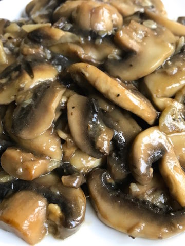 Tony's Sauteed Mushrooms - Sliced mushrooms sautéed in olive oil, flavored with garlic, then finished with a splash of wine. Makes a wonderful side or topping to just about anything.