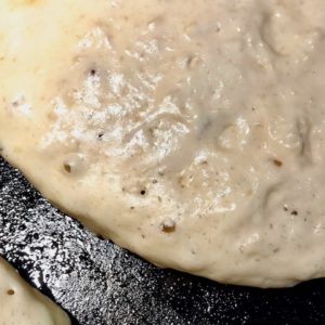 Bubbles forming on top of pancake in skillet.