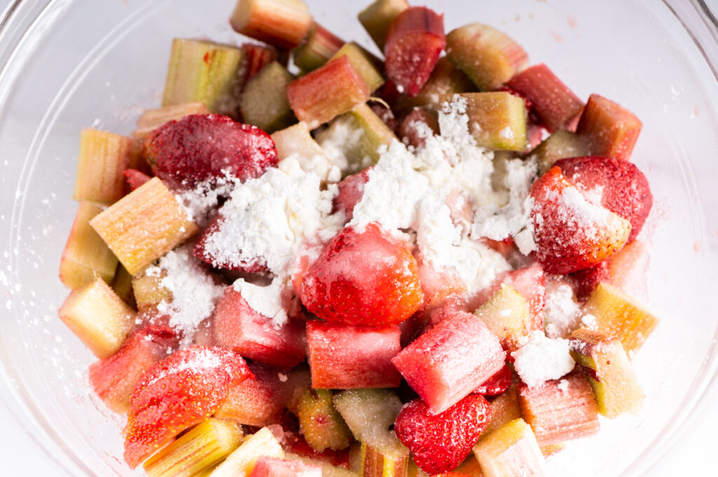 Cornstarch and sugar on top of chunks of strawberries and rhubarb.