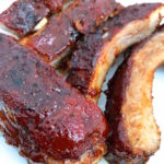 Tender, flavorful, Ultimate Oven Baked BBQ Ribs cooked low and slow. Rubbed with my Sweet and Spicy BBQ Rub and coated with my ten minute Sweet and Spicy BBQ Sauce. Perfection.