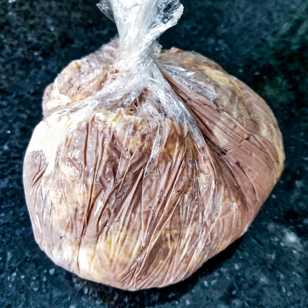 A mixture of cheddar cheese and port wine cheese formed into a ball and wrapped in plastic.