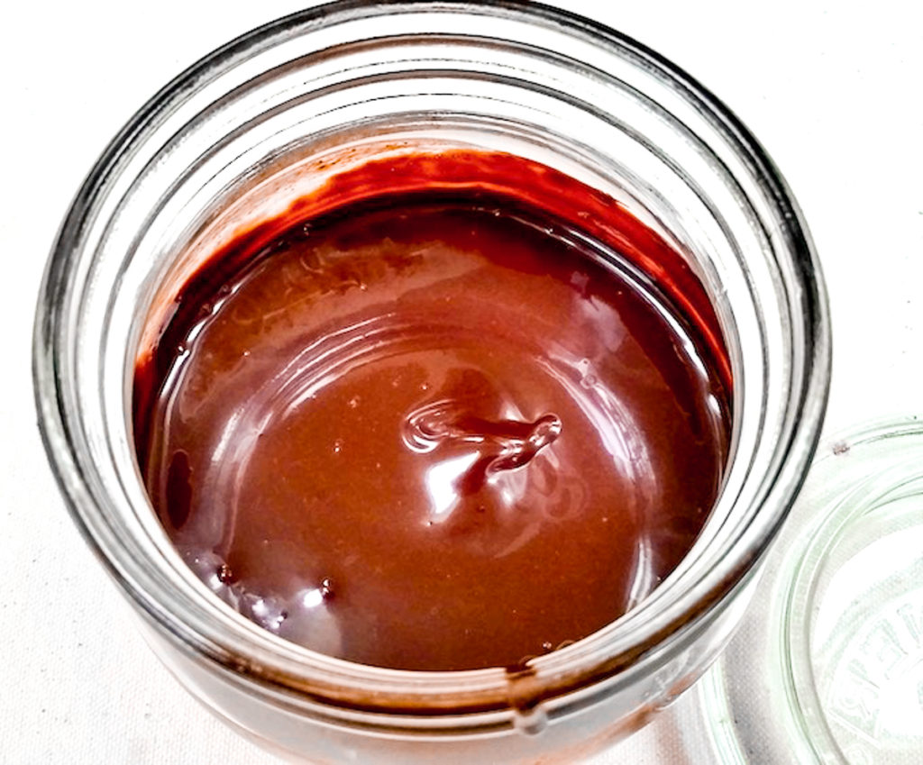 A jar of chocolate syrup.
