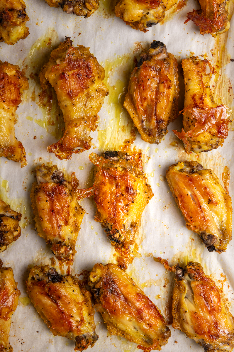 Golden brown adobo crack wings on a baking sheet.