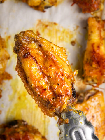 A golden adobo crack wing on a baking sheet.