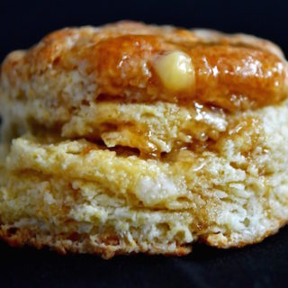 A Heavenly Buttermilk Biscuit dripping with honey and butter.