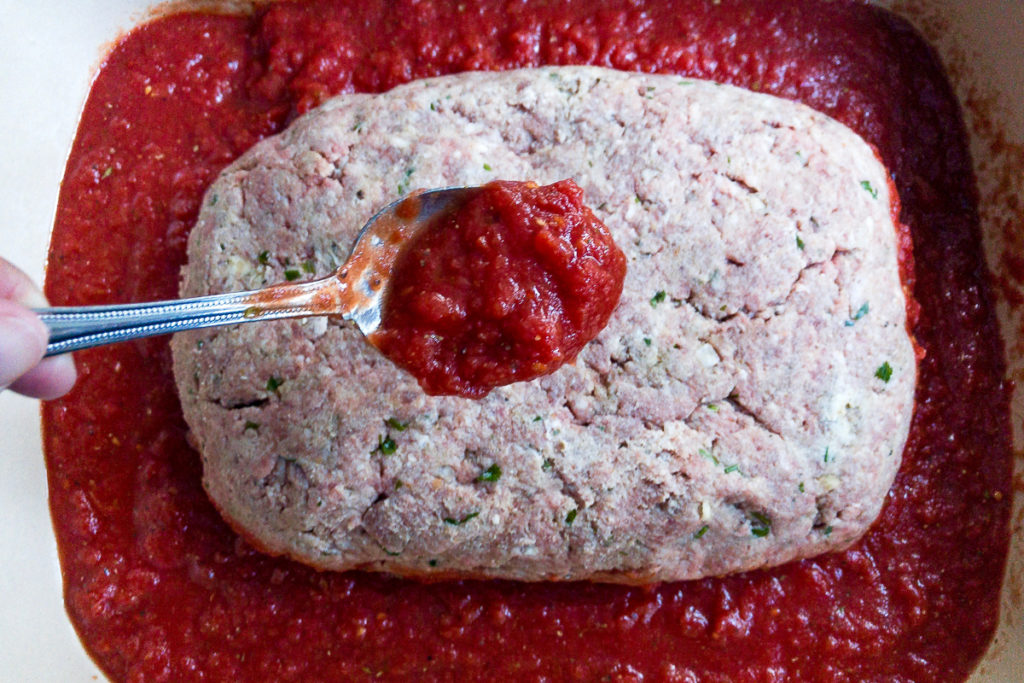 Italian meatloaf placed in baking dish.