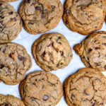 Perfectly baked chocolate chip cookies on a baking sheet.