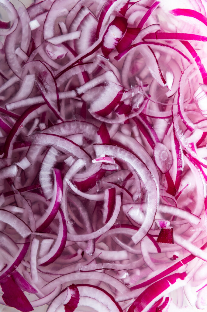 Sliced red onions ready to be rinsed.