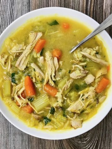A bowl of chicken and rice soup.