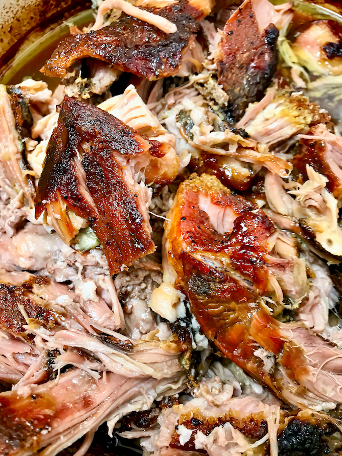 Pulled adobo pork butt in a pan.