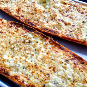 Diagonal closeup of creamy garlic bread.