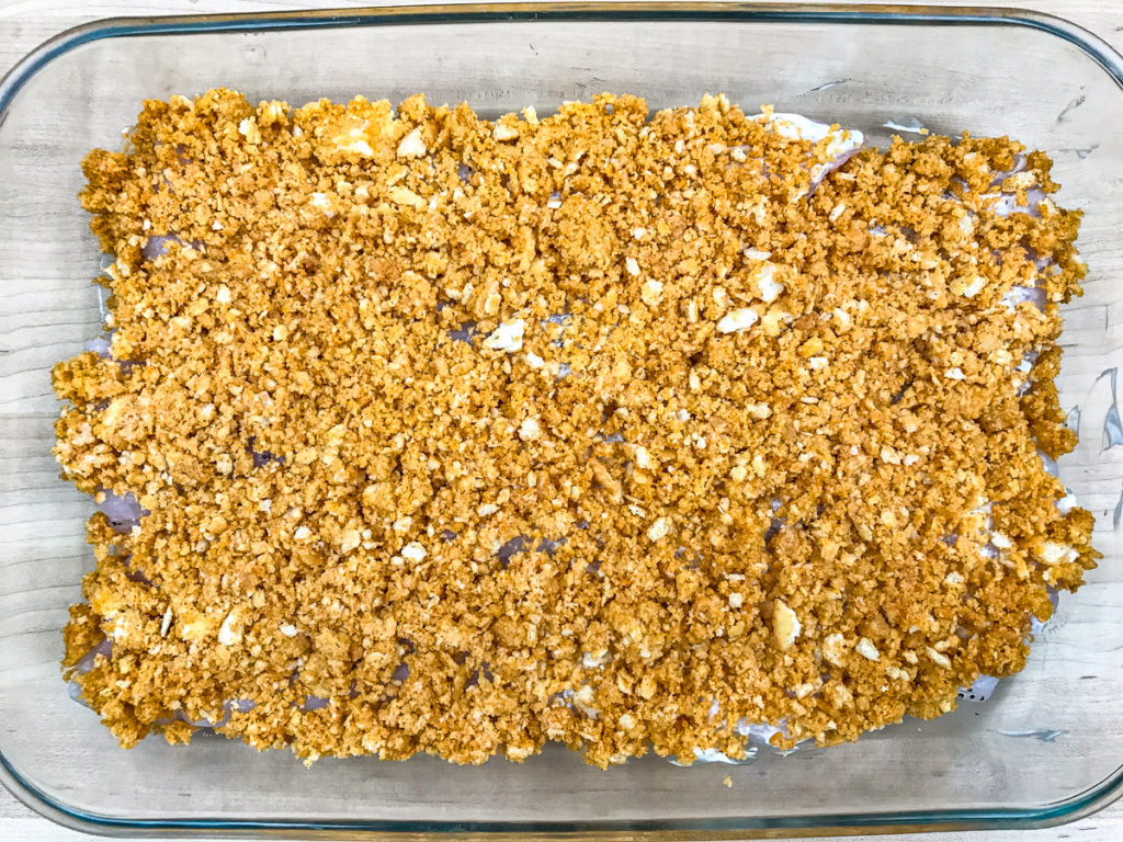 Ritz cracker crumbs covering haddock fillets in a baking dish.