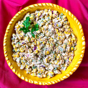 A yellow bowl of Mexican street corn salad.