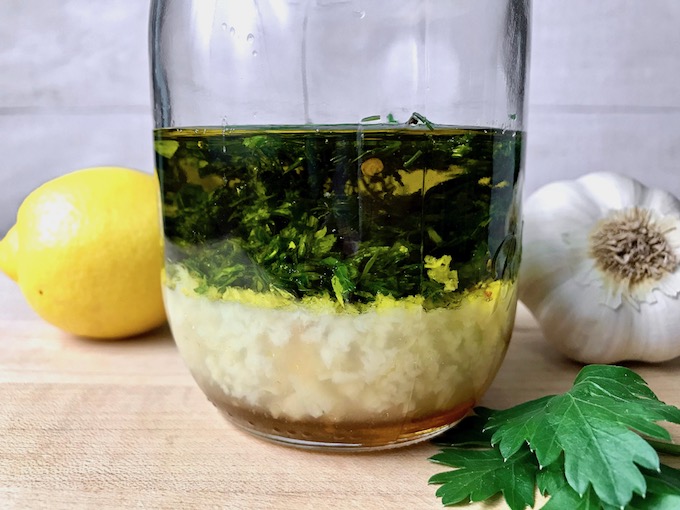 Ingredients for lemon herb vinaigrette in a mason jar.