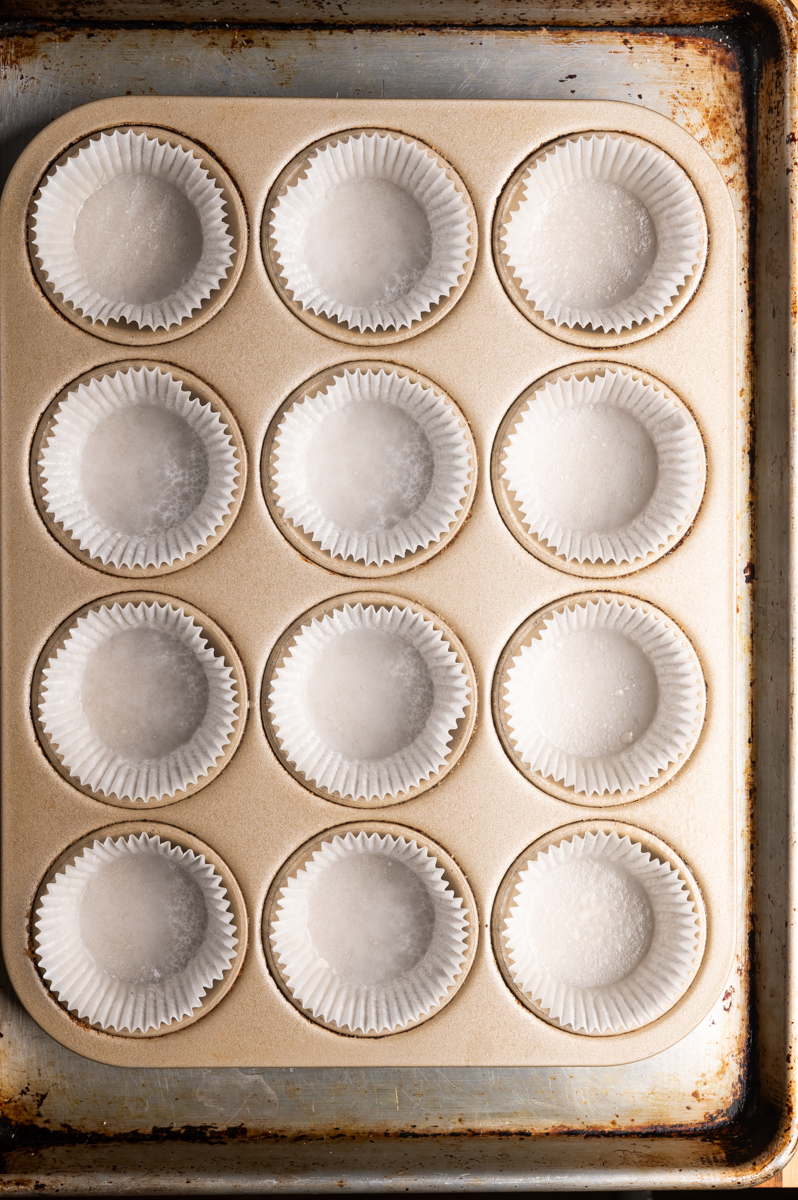 A muffin pan lined with paper liners.