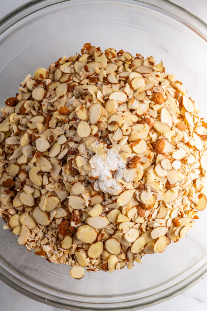 Oats, almonds, and salt in a bowl.