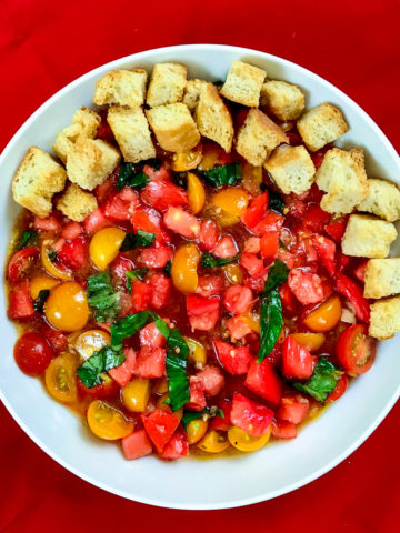 Tomato salad with toasted croutons on one side.