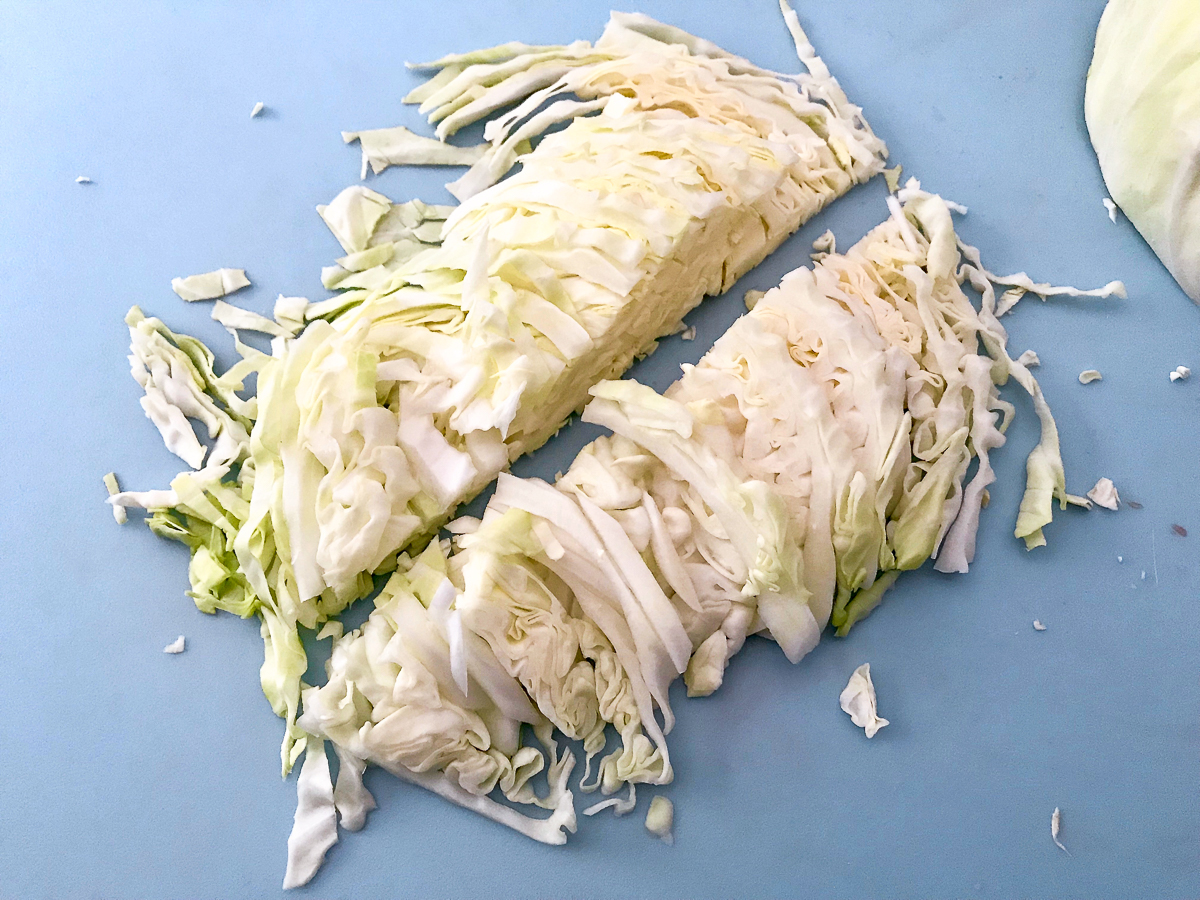 Sliced cabbage on a cutting board.