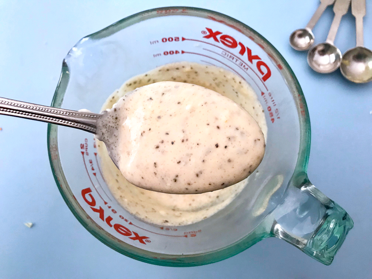 A spoonful of creamy coleslaw dressing.