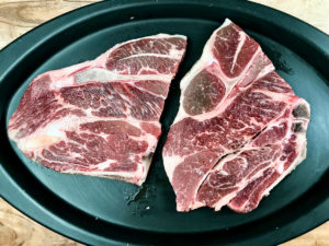 Two raw 7-bone chuck steaks.