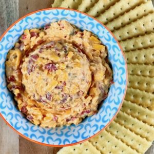 Pimento cheese in a bowl surrounded by crackers.