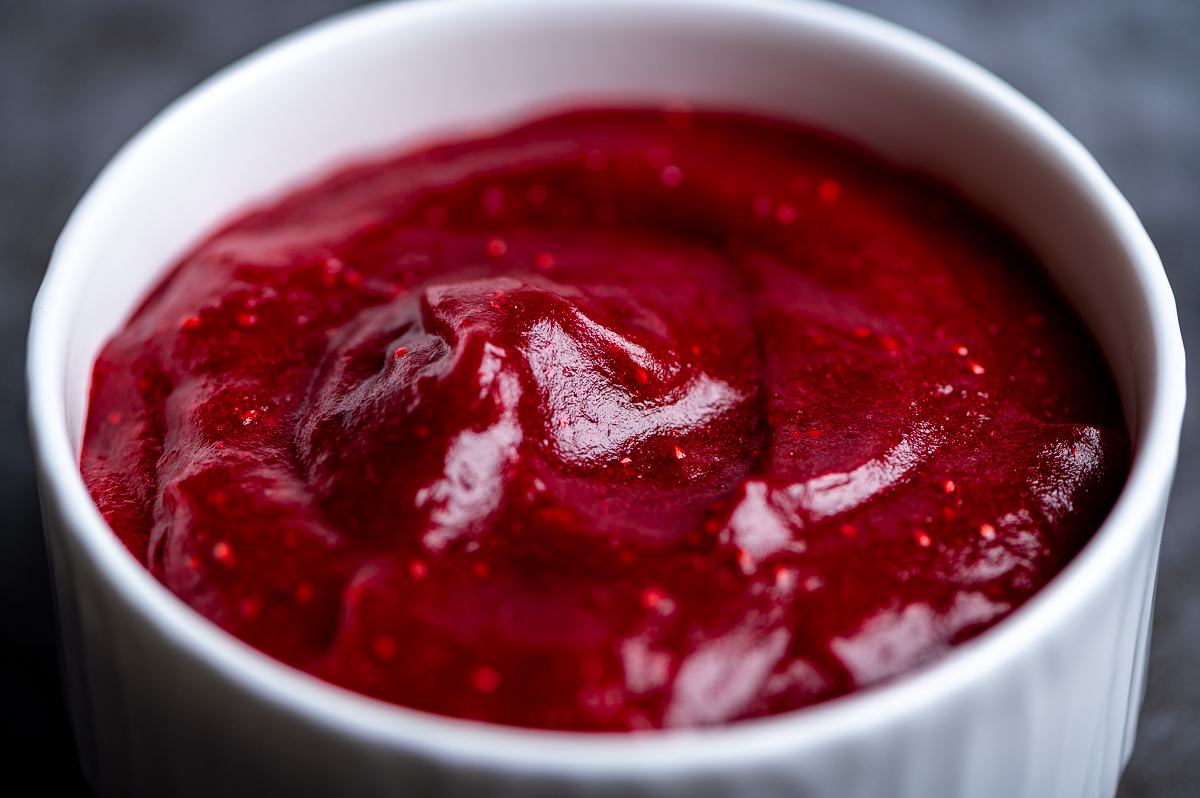 Closeup of cranberry sauce in a white bowl.