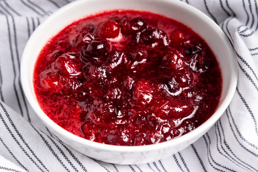 Chunky cranberry sauce in a white bowl.