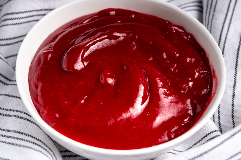 Jellied cranberry sauce in a white bowl.