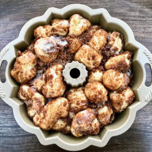 Coated monkey bread in bundt pan risen and ready to bake.