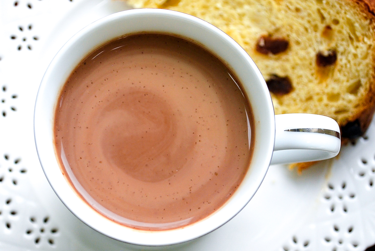 A cup of Peruvian hot chocolate with a slice of panettone.