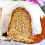 Closeup of a slice of banana bundt cake with cream cheese icing.