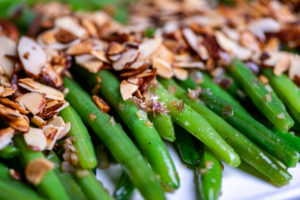 Green beans topped with sliced almonds.