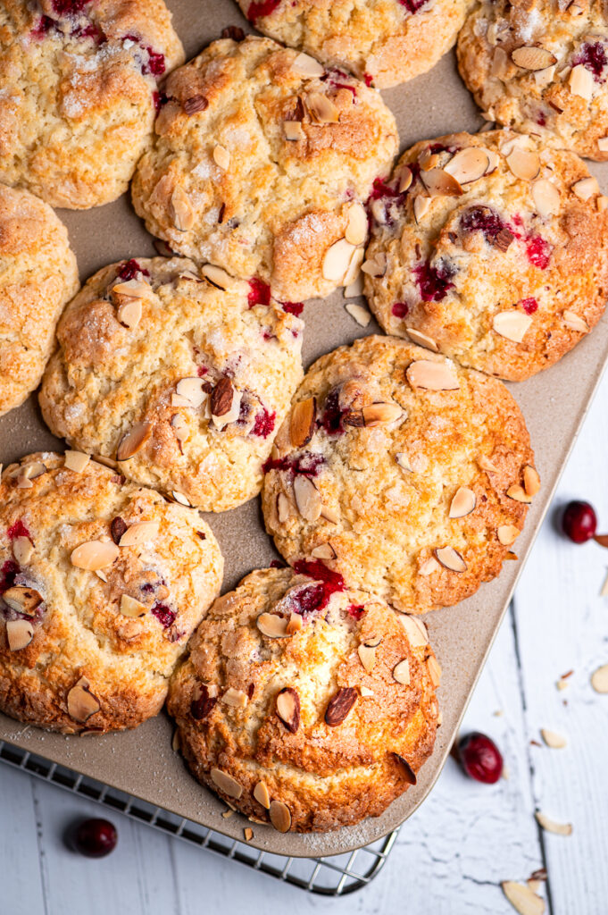 Baked cranberry muffins in a muffin pan.